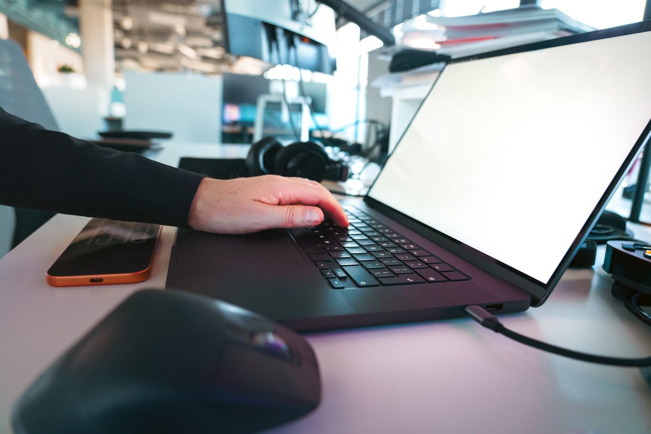 Crafting Captivating Headlines: Your awesome post title goes here Hand typing on a laptop keyboard in a sleek office environment, showcasing modern technology.
